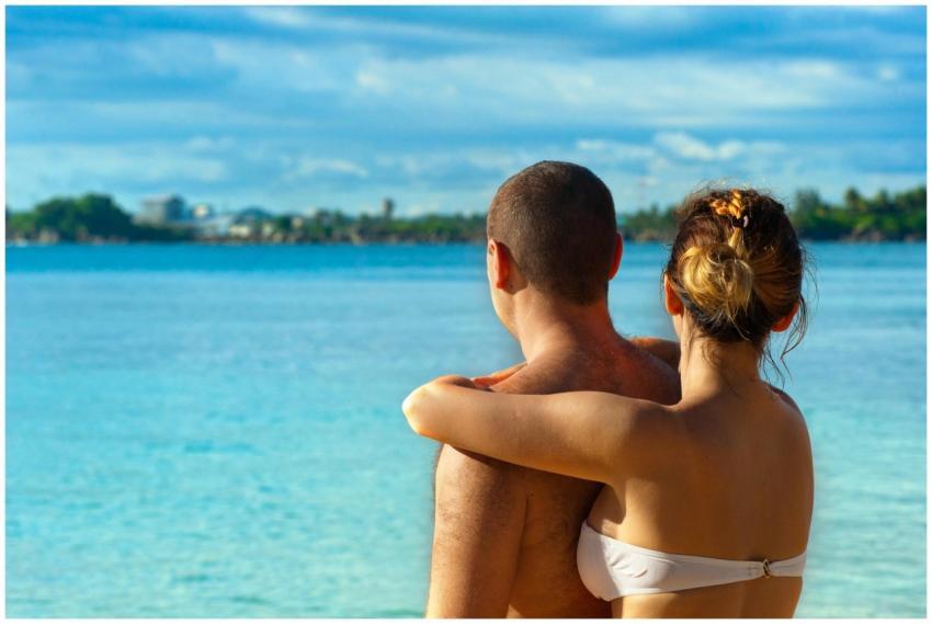 A couple embracing and enjoying the view at a sunn