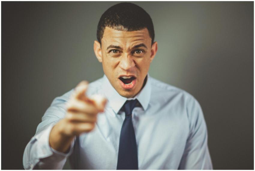 Close-up of an angry businessman in a tie expressi