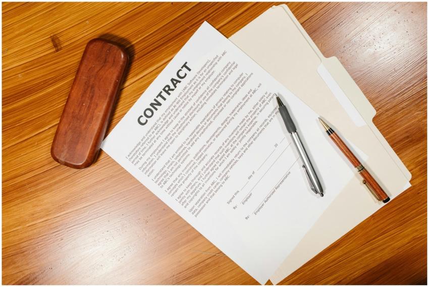 High-angle view of a contract document with pens a