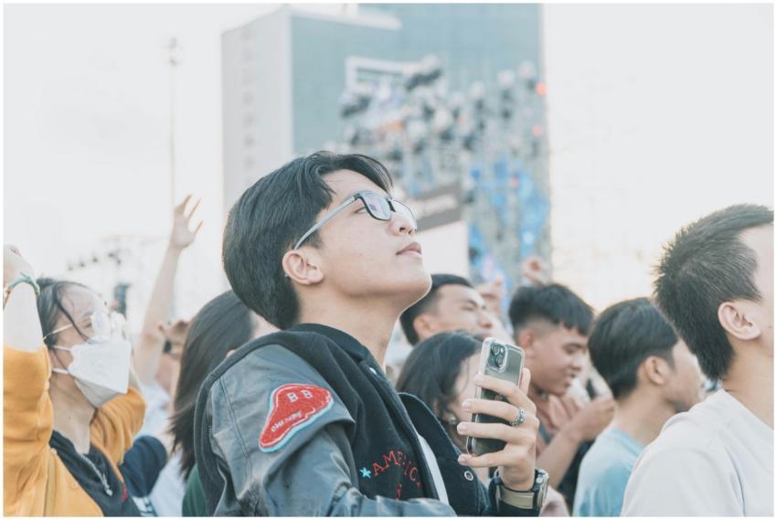 A diverse crowd of young adults enjoying an outdoo