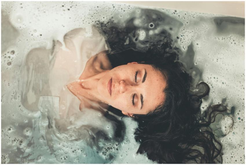 Woman with long hair enjoying a peaceful bubble ba