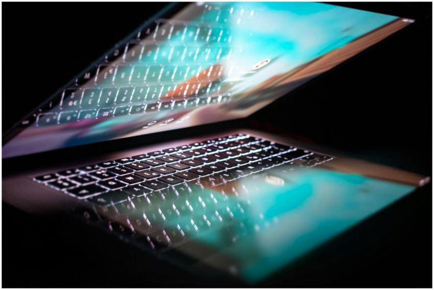 Close-up of a modern laptop with illuminated keybo