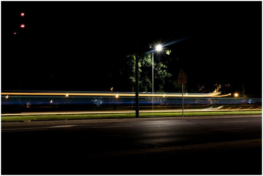 Night highway scene with light streaks from passin
