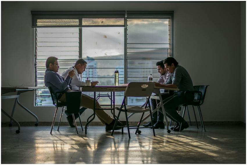 Four coworkers gathered around a table in a modern
