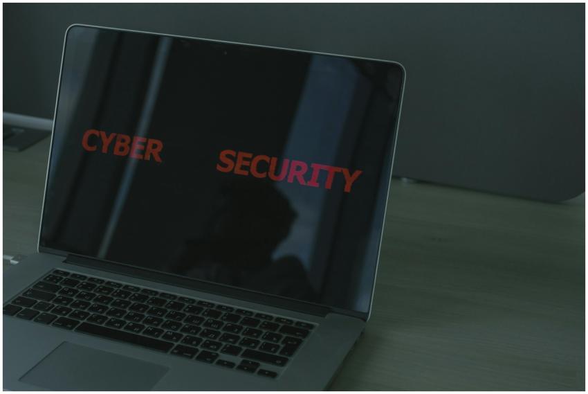 Close-up of a laptop displaying cybersecurity text
