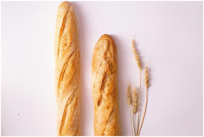 Pair of fresh baguettes on a white background with