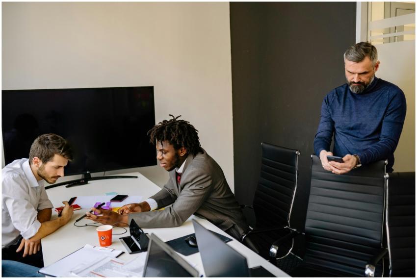 Business colleagues discussing projects around a c