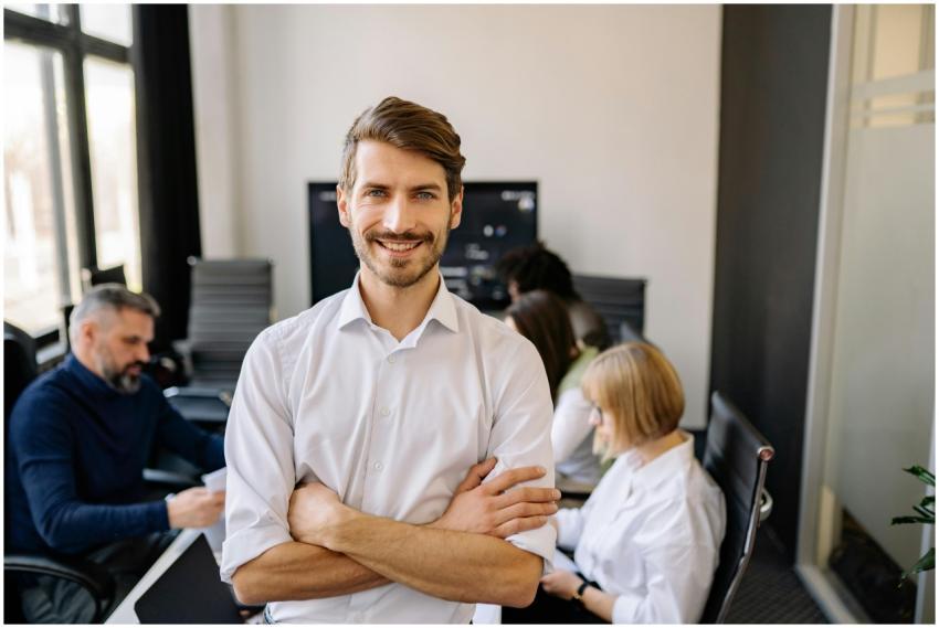Smiling businessman standing confidently with arms