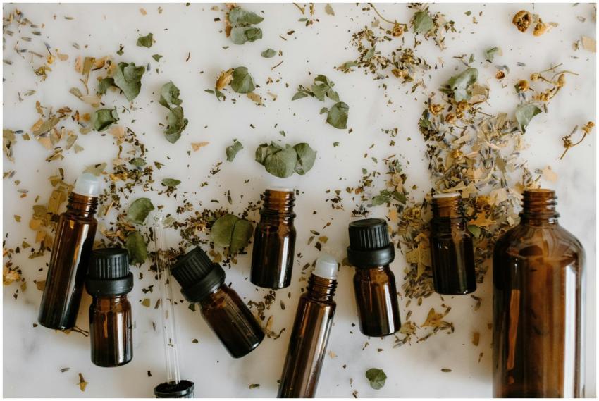 Flat lay of brown glass bottles and dried herbs, p