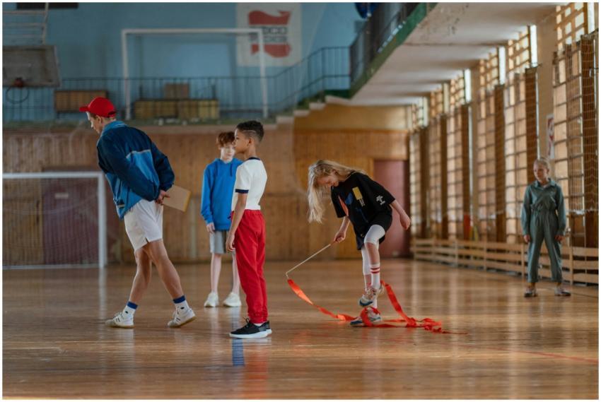 Children practicing gymnastics in a sports hall wi