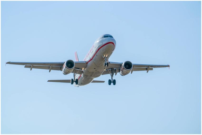 An Airbus A320 in flight descending over Manises,