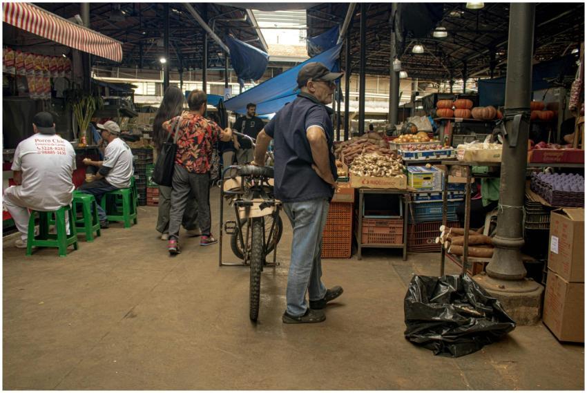 A vibrant indoor market with vendors and customers