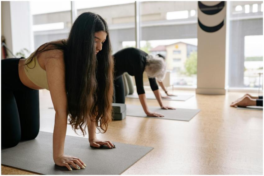 Women of different ages practicing yoga indoors, f