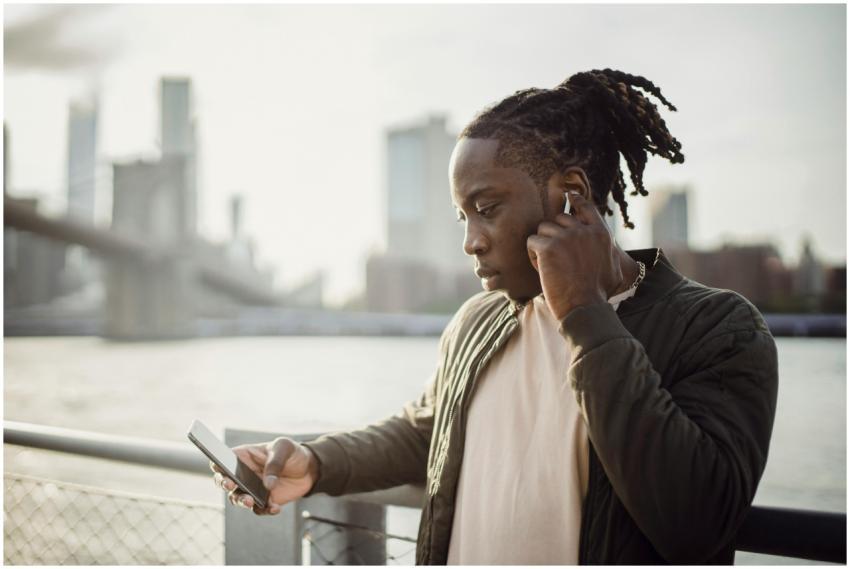 Thoughtful adult African American guy in wireless