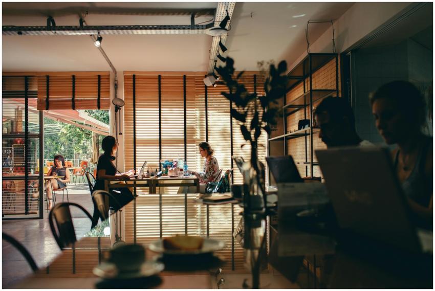 Interior of a bustling café with people working on