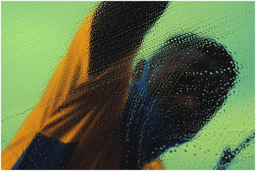 Anonymous man in São Paulo washing glass with soap