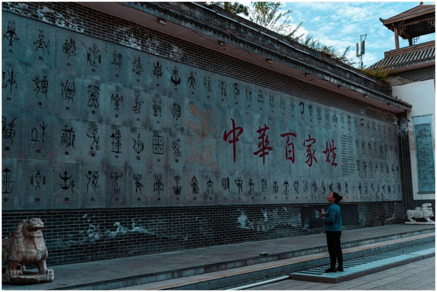 A person admires an ancient Chinese script wall ou