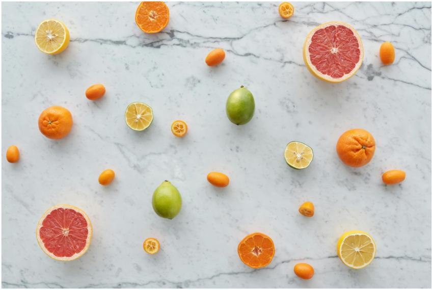 Colorful citrus fruits arranged on a marble surfac