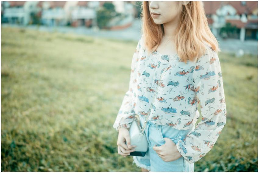 Young woman with blonde hair in a patterned blouse
