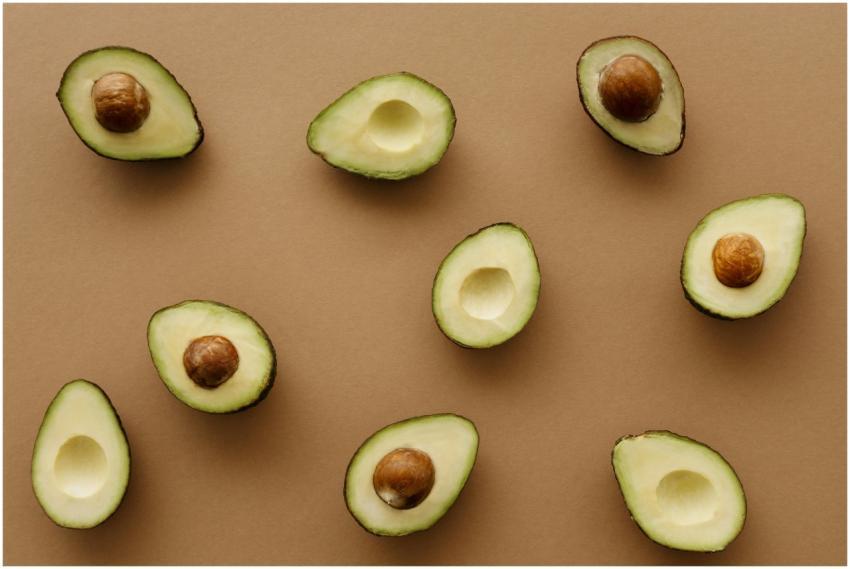 Aesthetic flat lay of ripe avocado halves arranged
