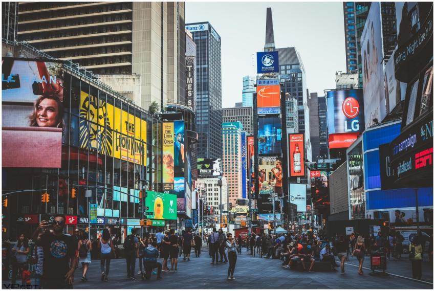 Bustling daytime view of Times Square with crowds,