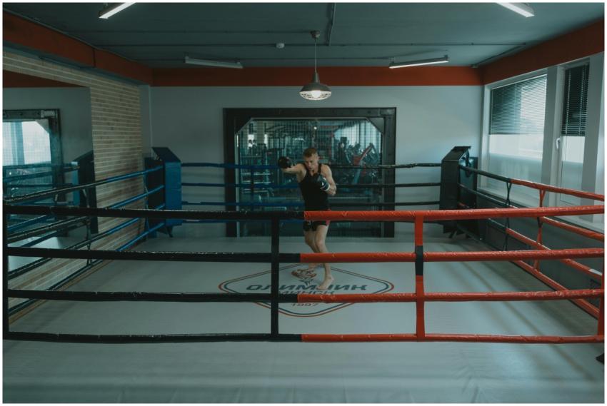 A professional boxer training alone in a well-lit