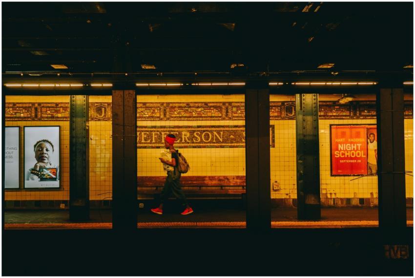 A person wearing bright sneakers walks through Jef