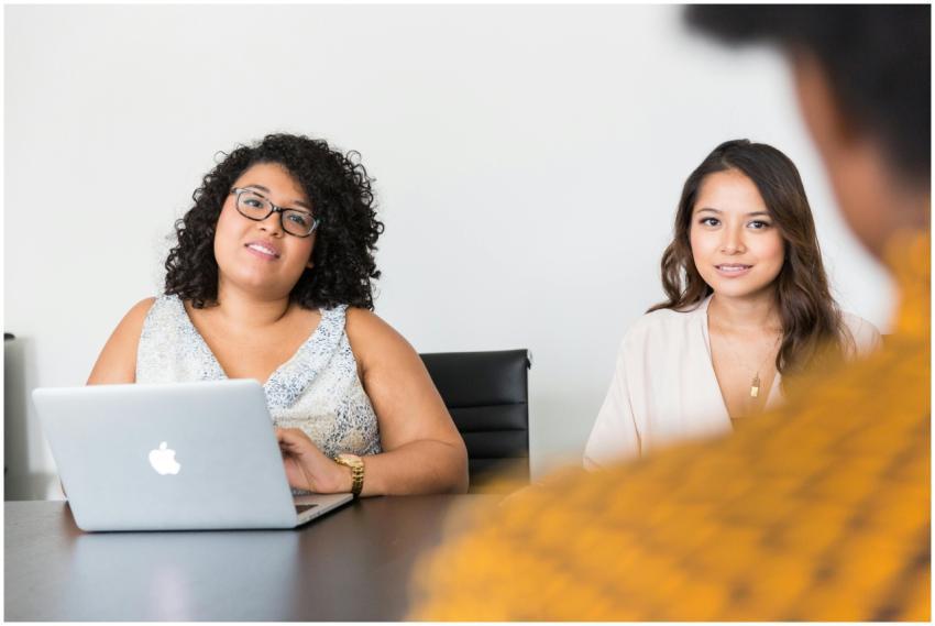 Diverse women engaged in a business meeting with l