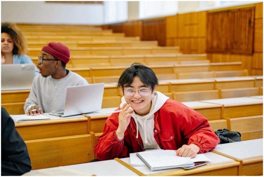 Smiling students studying together in a university