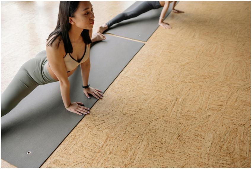 Young woman performing yoga pose on mat in studio