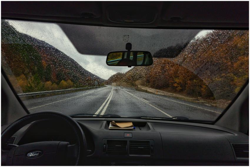 View through a car windshield on a rainy day, show