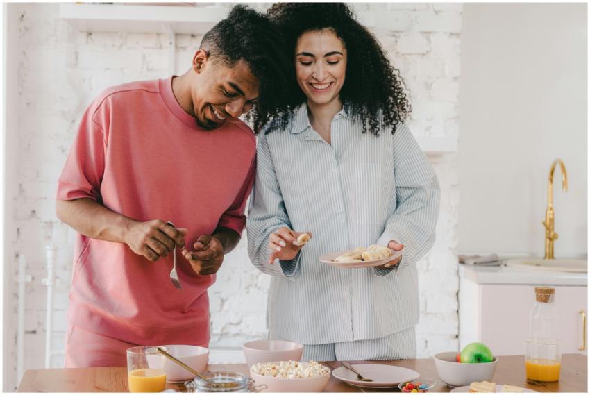 Smiling couple with curly hair sharing a cozy brea