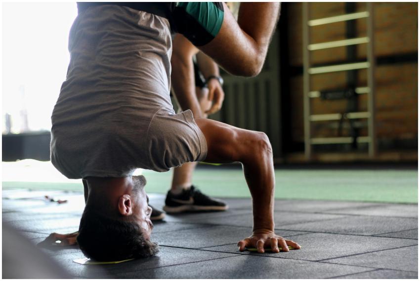 Adult man showcasing balance and strength with a h