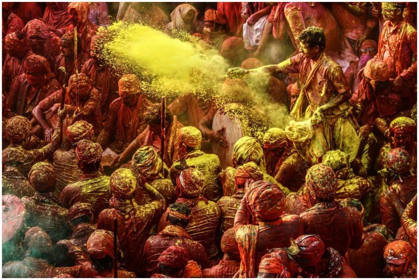 Crowd celebrating Holi festival with colorful powd
