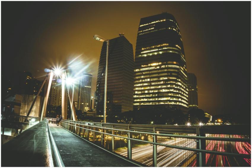 Vibrant urban night scene featuring modern skyscra