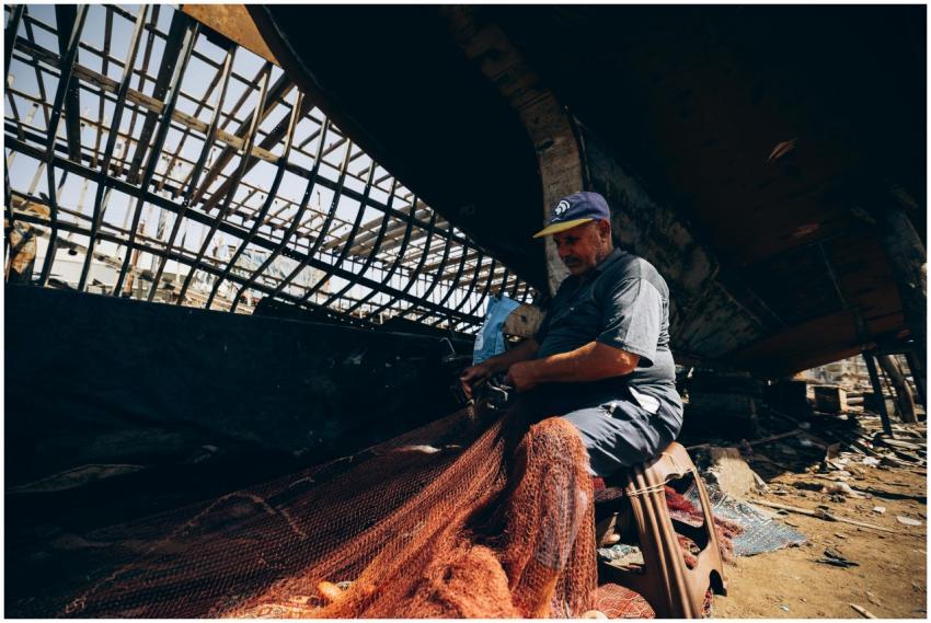 A fisherman in Damietta, Egypt, skillfully repairi