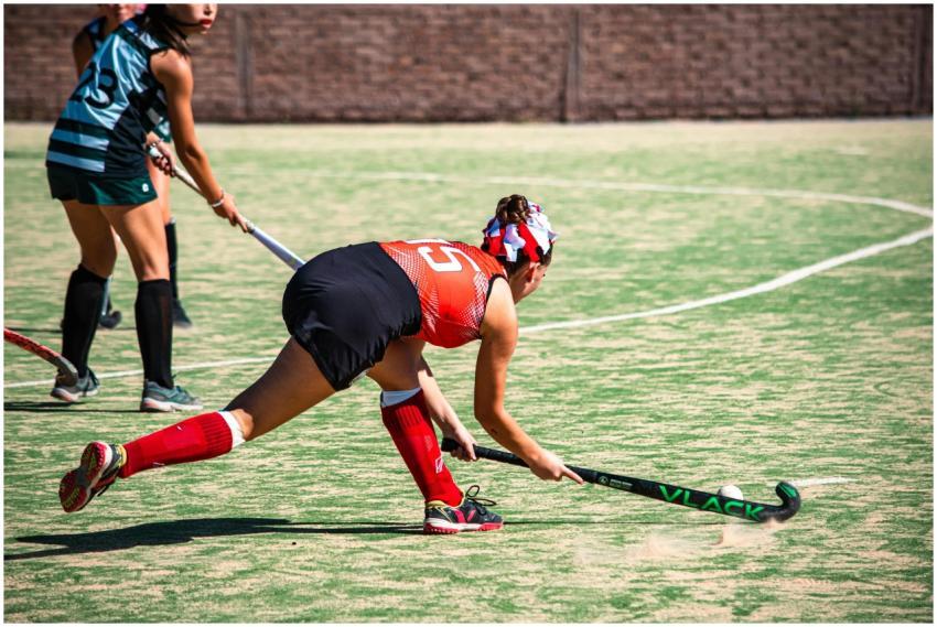 Dynamic field hockey game with women in action on