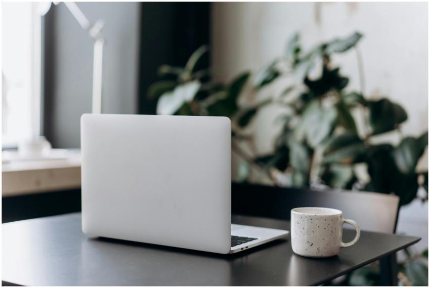 A minimalist workspace featuring a closed laptop a