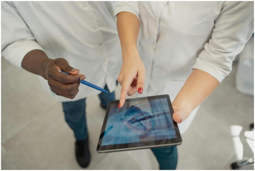 Two medical professionals analyzing a dental x-ray