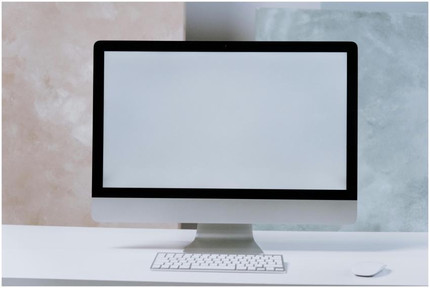 A sleek iMac desktop computer on a minimalist whit