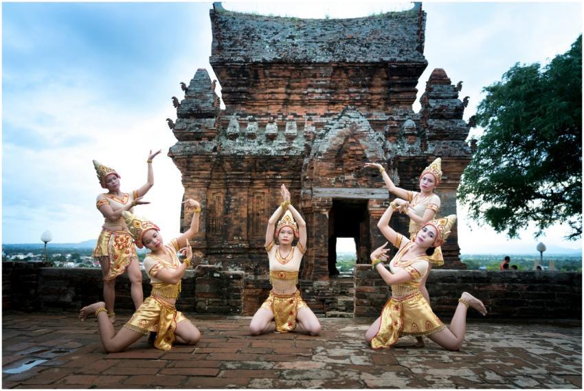 Traditional dancers in golden costumes perform at