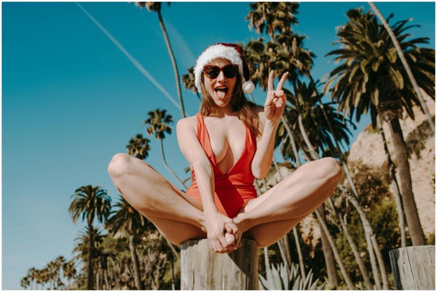 Woman enjoying Christmas at the beach wearing a Sa