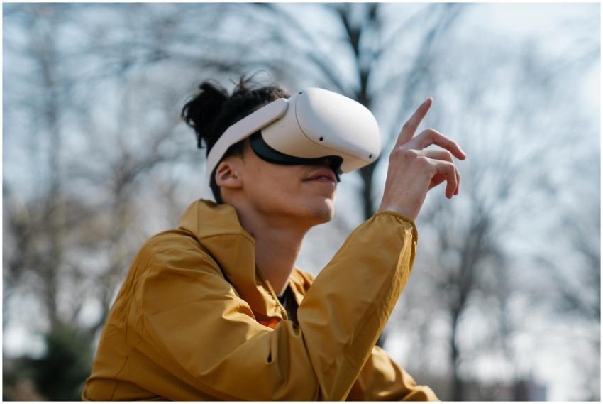 A young adult using a virtual reality headset outd