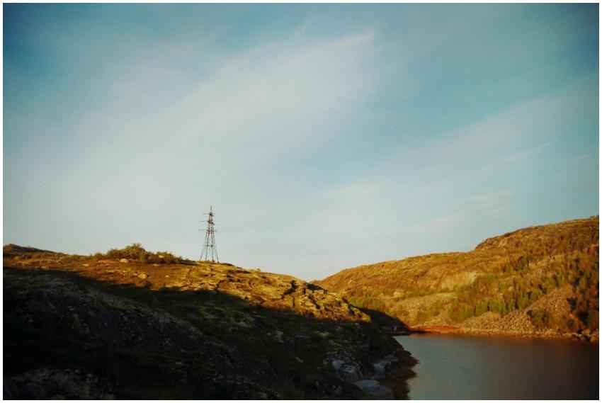 A tranquil rural landscape featuring hills, power