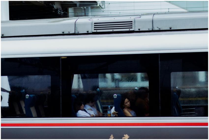 Commuters relax inside a train compartment in Japa