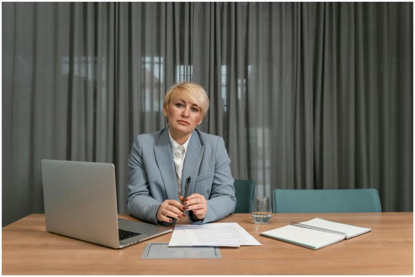 A confident businesswoman with short hair sits at