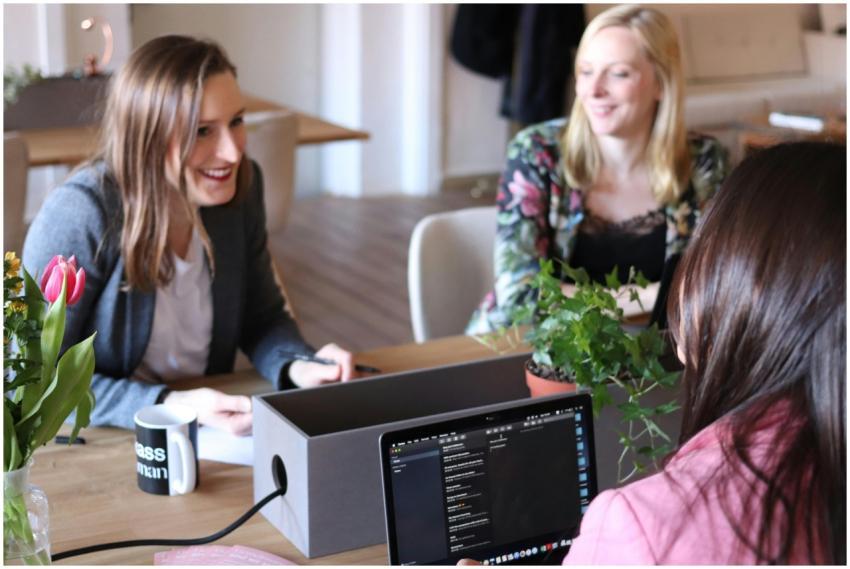 Three women engaging in a casual business meeting