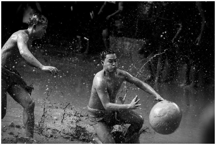 Energetic scene of two men playing soccer in the m