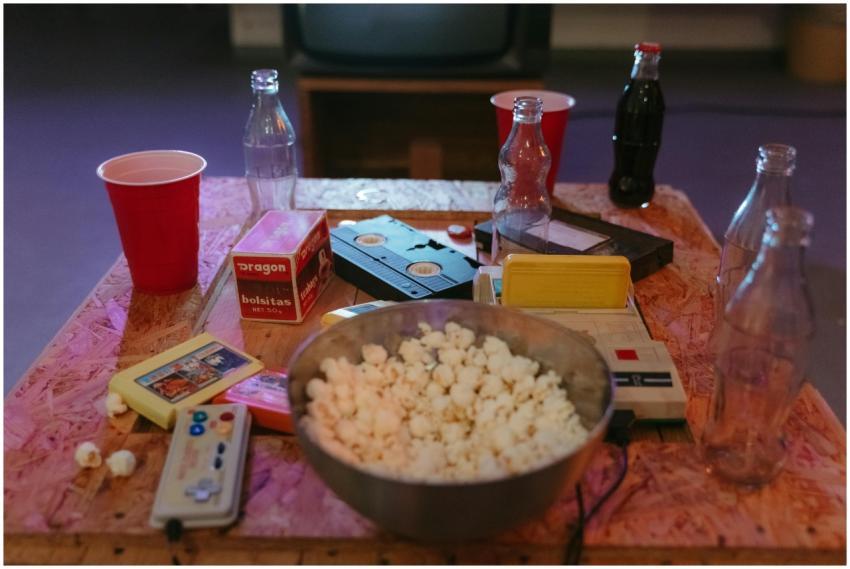 A nostalgic setup with popcorn, VHS tapes, and ret