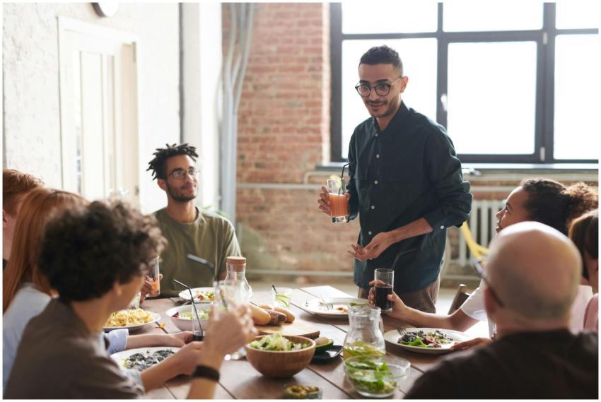 A group of friends enjoy a meal together in a mode